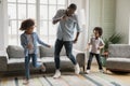 Young biracial father dancing with little children Royalty Free Stock Photo