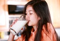 Young biracial girl drinking milk