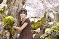 Young biracial girl in flowering cherry tree