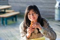 Young biracial teen girl eating hamburger