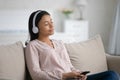 Young biracial woman in headphones listen to music on cell Royalty Free Stock Photo