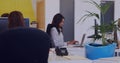 Young biracial woman works diligently at her office desk