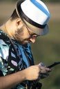 Young bird watcher identifies a bird in the field using a cell phone Royalty Free Stock Photo