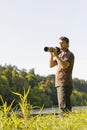Young bird watcher with photo camera