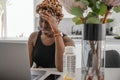 Young Black African business woman, hand on head, stressed looking at laptop Royalty Free Stock Photo