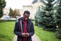 Young black African man in city texting cell phone email Royalty Free Stock Photo