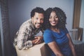 Young black african man and his girlfriend moving boxes into new house together and making a beautiful life.Cheerful