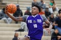 Young black basketball player in a blue jersey dunking the ball Royalty Free Stock Photo