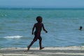 A Young Black Boy Running on Beach