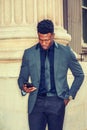 Young black businessman texting on cell phone outside office building in New York City Royalty Free Stock Photo