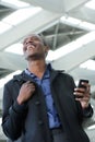 Young black businessman walking with cellphone Royalty Free Stock Photo