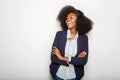 Young black businesswoman laughing against gray wall Royalty Free Stock Photo