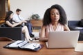 Young black businesswoman using laptop at a desk