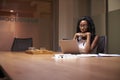 Young black businesswoman working late alone in office Royalty Free Stock Photo