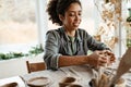 Young black ceramist woman sculpting in clay at her workshop