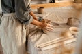 Young black ceramist woman sculpting in clay at her workshop