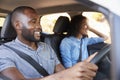 Young black couple in car on a road trip look ahead smiling Royalty Free Stock Photo