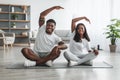 Young black couple doing side bend exercise together Royalty Free Stock Photo