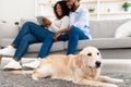 Young black couple at home with tablet and labrador Royalty Free Stock Photo