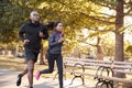 Young black couple jogging in a Brooklyn park, three quarter len Royalty Free Stock Photo