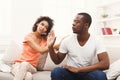 Young black couple making peace after quarreling at home Royalty Free Stock Photo