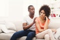 Young black couple making peace after quarreling at home Royalty Free Stock Photo