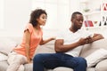 Young black couple making peace after quarreling at home Royalty Free Stock Photo