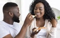 Young black couple sharing pizza on date at home