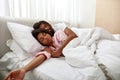 Young black couple sleeping under blanket on bed Royalty Free Stock Photo