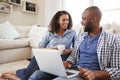 Young black couple using laptop at home look at each other Royalty Free Stock Photo