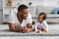 Young Black Dad And His Adorable Infant Child Relaxing Together At Home Royalty Free Stock Photo