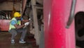 Young black engineer maintenance and repair train diesel engine in station.