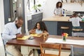 Young black family busy in their kitchen, elevated view