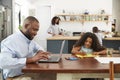 Young black family busy working in their kitchen Royalty Free Stock Photo