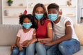 Young Black Family Wearing Face Masks Showing Adhesive Bandage After Coronavirus Vaccination