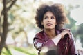 Young black woman with afro hairstyle standing in urban background Royalty Free Stock Photo