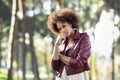 Young black woman with afro hairstyle standing in urban backgrou Royalty Free Stock Photo