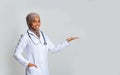 Young Black Female Doctor Holding Invisible Item On Her Palm