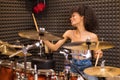 Young black female drummer in a recording studio