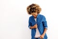 Young black female looking down and smiling on white background Royalty Free Stock Photo