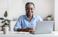Young Black Female Office Employee Sitting At Workplace With Smartphone In Hands Royalty Free Stock Photo