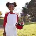 Young Black girl with baseball mitt, smiling, square format