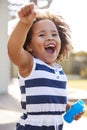 Young black girl blowing bubbles outside her home Royalty Free Stock Photo