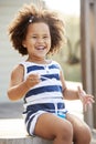 Young black girl blowing bubbles outside her home Royalty Free Stock Photo