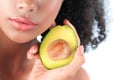 Young black girl with clean perfect skin with avocado close-up