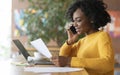 Young black girl editor talking to clients on phone