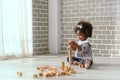 Young black girl is having fun playing and learning to strengthen her cognitive skills at home