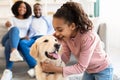 Young black girl hugging with dog and whispering secret Royalty Free Stock Photo