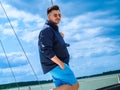 Young black hair man wear in sunglasses and nautical cloth standing on a sailing boat during his summer sailing voyage