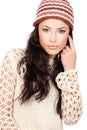 Young black hair woman in wool sweater and cap